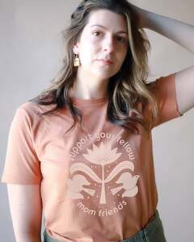 Front of a model wearing a size Large Support Your Fellow Mom Friends Graphic Tee in Toasted Nut by Polished Prints. | dia_product_style_image_id:239758